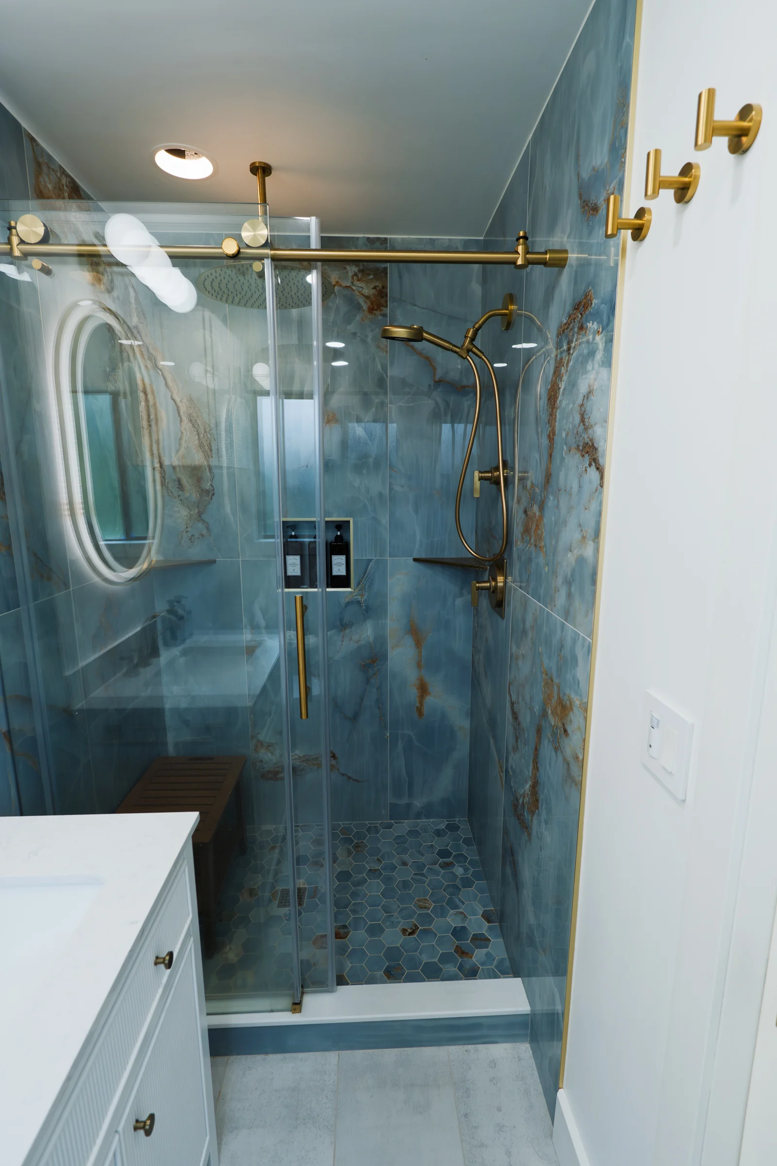 Complete bathroom remodel with glass shower, brass fixtures, and custom vanity, Portland OR